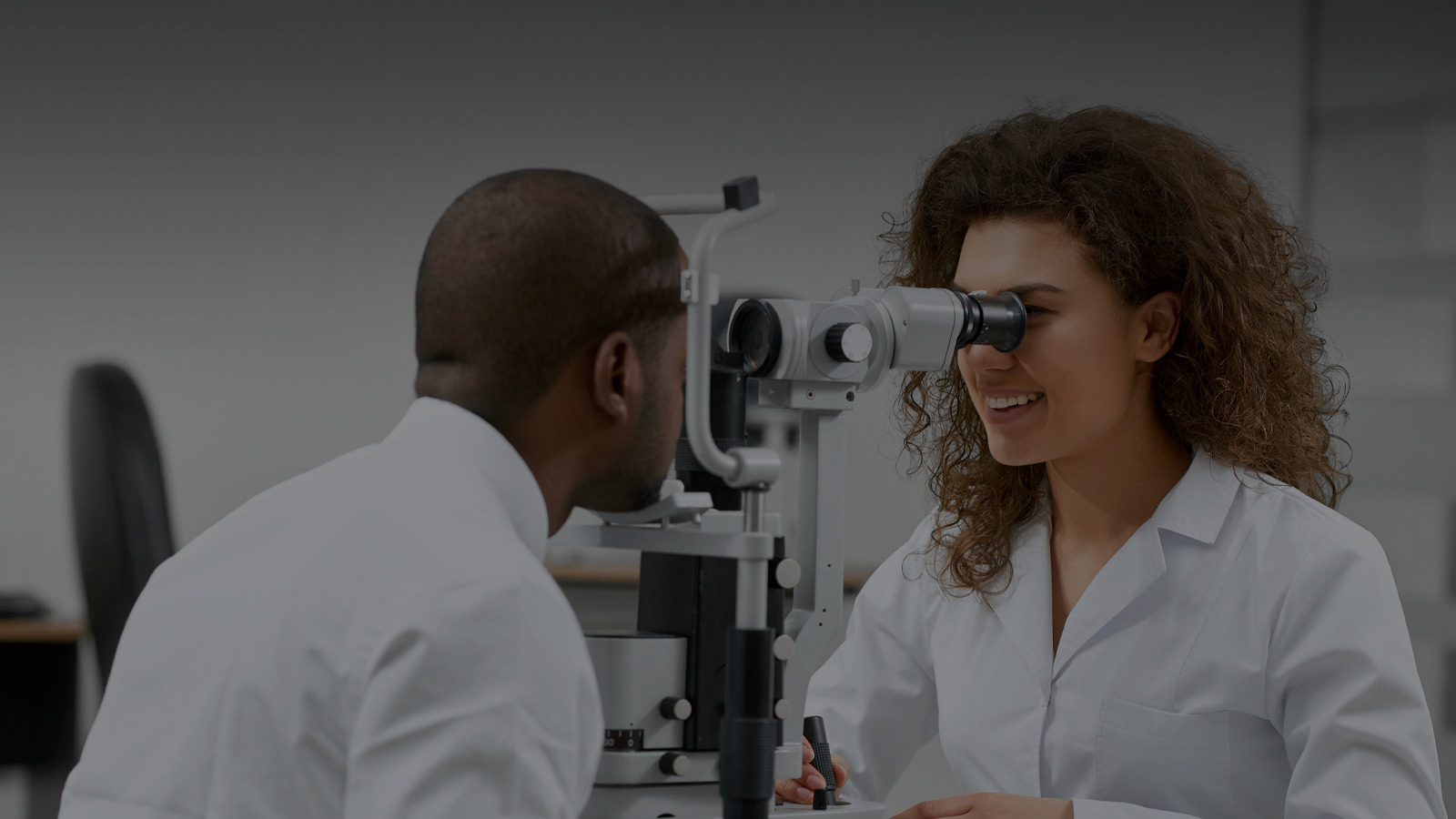 The doctor is checking her patient's eyes