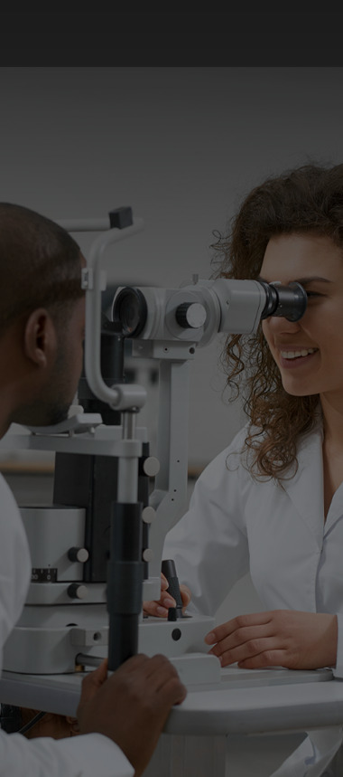 The doctor is checking her patient's eyes