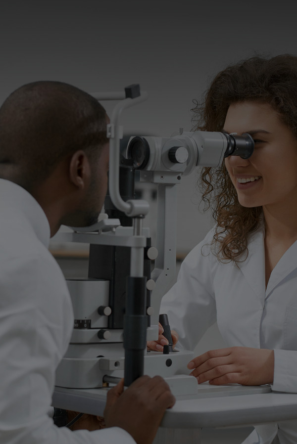 The doctor is checking her patient's eyes