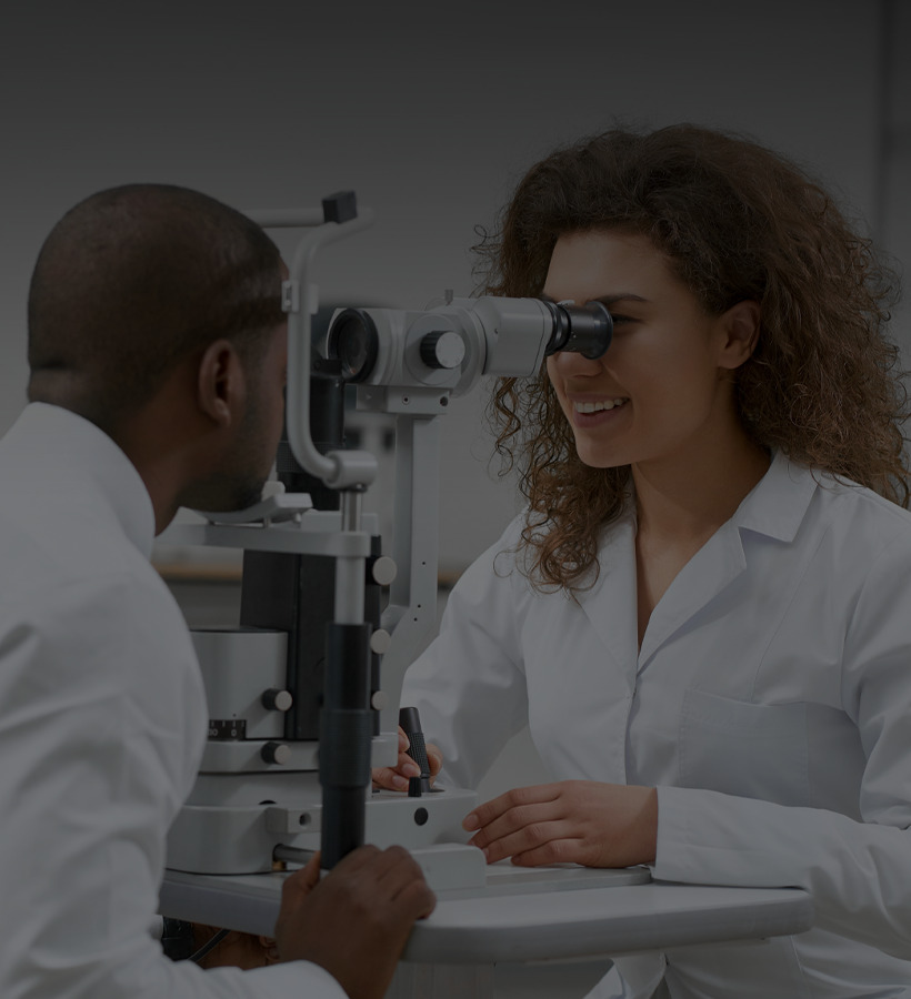 The doctor is checking her patient's eyes
